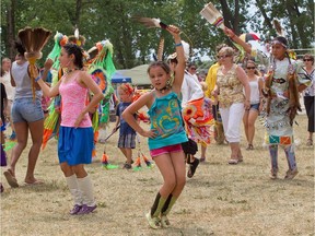 Members of the public, non-competitors and competitors are invited to dance prior to competitions at the Echoes of a Proud Nation Pow-Wow in Kahnawake near Montreal Sunday, July 15, 2012.