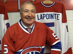 Former Canadiens defenceman Guy Lapointe poses next to his No. 5 jersey following the announcement by the club on June 19, 2014 that his jersey would be retired.