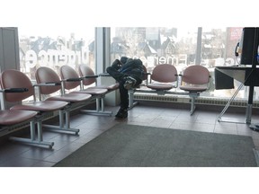 A man waits in the overflow area of the Montreal General Hospital emergency room in Montreal Wednesday March 24, 2010.