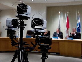 Pointe-Claire Mayor Morris Trudeau, right, listens to questions during the first city council meeting to be web broadcast under a pilot test program in March 2014.