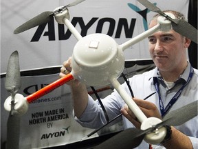 Sébastien Long from Avyon Higher solutions, gets a closer look at his company's drone on Wednesday November 05, 2014. The MD4-200 is part of the Unmanned Systems Canada annual convention being held in Montreal this week.