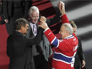 Guy Lapointe, right  with his former teammates Serge Savard, left, and Larry Robinson during the retirement of his number at the Bell centre in Montreal on Saturday November 08, 2014.