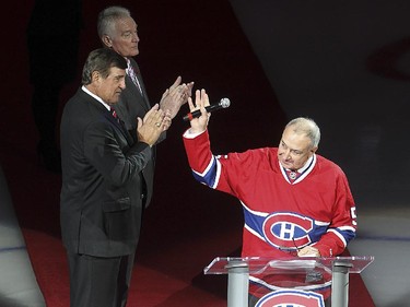 Guy Lapointe  waves to crowd with his former teammates Serge Savard and Larry Robinson looking on in background, during the retirement of his number at the Bell centre in Montreal on  Saturday November 08, 2014.