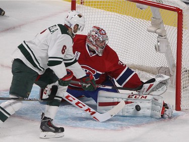 Montreal Canadiens goalie Carey Price makes save on Minnesota Wild defenseman Marco Scandella during first period NHL action in Montreal on Saturday November 08, 2014.