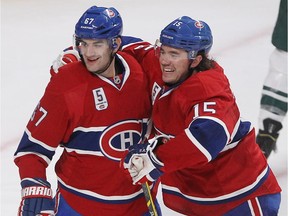 The Canadiens' Max Pacioretty, left, celebrates after scoring a goal with teammate P.A. Parenteau during game against the Minnesota Wild at the Bell Centre on Nov. 8, 2014.