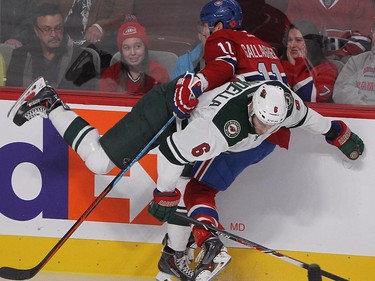 Montreal Canadiens right wing Brendan Gallagher and Minnesota Wild defenseman Marco Scandella, front, hit in the boards during first period NHL action in Montreal on Saturday November 08, 2014.