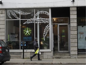 A pedestrian passes in front of Santé Cannabis which opened its doors officially on Tuesday in Montreal. It's the first and perhaps the only medical clinic specializing in medical pot.