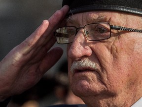 Captain (retired) Paul Veilleux, Royal 22nd Regiment pays homage to fallen comrades during Remembrance Day Ceremonies at the cenotaph at the St-Jean Garrison in Saint-Jean-sur-Richelieu, on Tuesday, November 11, 2014.