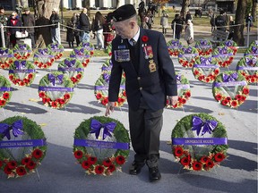 James Riddell, VP of the Royal Canadian Legion Quebec Provincial Command, gets a closer look at Remembrance Day wreaths, prior to ceremonies held at McGill University on  Tuesday November 11, 2014.