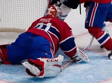 Habs goalie Carey Price searches for a loose puck during action against the Jets at the Bell Centre on Tuesday, Nov. 11, 2014.