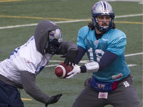 Alouettes quarterback Jonathan Crompton hands the ball off to Brandon Rutley during practice at Stade Hébert on Nov. 12, 2014.