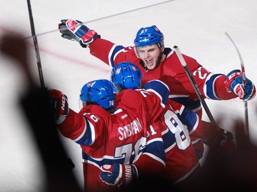 Alex Galchenyuk (top) and P.K. Subban (left) of the Montreal Canadiens celebrate a goal by teammate Lars Eller (centre) against the Boston Bruins in the second period of an NHL game, Thursday, November 13, 2014 at the Bell Centre.