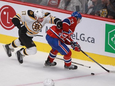 Alexei Emelin of the Montreal Canadiens keeps the puck away from Milan Lucic of the Boston Bruins in third period of an NHL game Thursday, November 13, 2014 at the Bell Centre in Montreal.