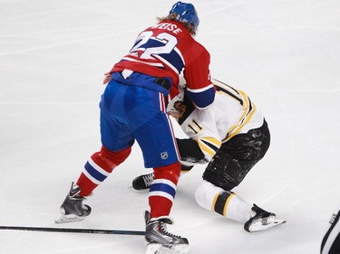 Dale Weise of the Montreal Canadiens and Gregory Campbell of the Boston Bruins fight in the first period of an NHL game at the Bell Centre in Montreal, Thursday, November 13, 2014.
