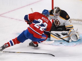 Dale Weise of the Montreal Canadiens is hauled down as he attempts to score against Niklas Svedberg of the Boston Bruins in the second period of an NHL game Thursday, November 13, 2014 at the Bell Centre in Montreal.  Weise was awarded a penalty shot and scored.