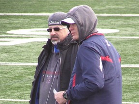 MONTREAL, QUE.: NOVEMBER 13, 2014 -- Montreal Alouettes coach Tom Higgins, right, speaks with Alouettes general manager Jim Popp, during practice at stade Hébert on Thursday November 13, 2014. (Pierre Obendrauf / MONTREAL GAZETTE)