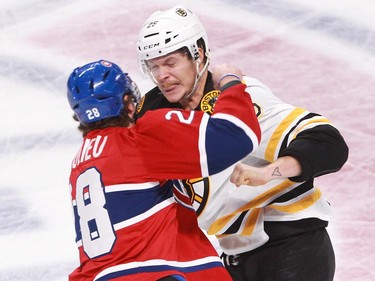 Nathan Beaulieu of the Montreal Canadiens and Matt Fraser of the Boston Bruins fight in the second period on an NHL game Thursday, November 13, 2014, at the Bell Centre in Montreal.