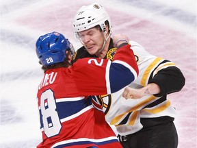 The Canadiens' Nathan Beaulieu drops the gloves with the Boston Bruins' Matt Fraser during game at the Bell Centre on Nov. 13, 2014.