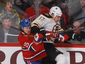 P.A. Parenteau of the Montreal Canadiens gets an elbow to the jaw from Milan Lucic of the Boston Bruins in the first period of an NHL game Thursday, November 13, 2014 at the Bell Centre in Montreal.