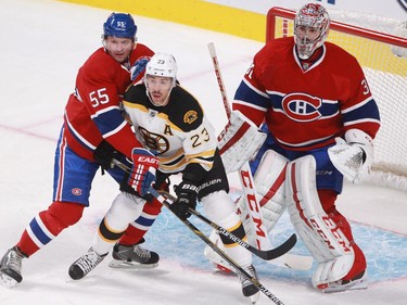 Sergei Gonchar of the Montreal Canadiens and Chris Kelly of the Boston Bruins battle in front of goalie Carey Price in the first period on an NHL game, at the Bell Centre in Montreal, Thursday, November 13, 2014.