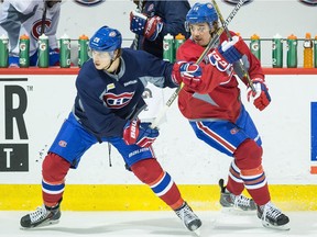 Canadiens' Nathan Beaulieu, left, and P.A. Parenteau battle for position during practice at the Bell Sports Complex in Brossard on Nov. 14, 2014.