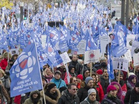 Employees and supporters of CBC/Radio-Canada march along Beaver Hall Hill in Montreal, Sunday, November 16, 2014, to protest cuts to the corporation.