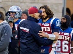 Alouettes quarterback Jonathan Crompton is congratulated by head coach Tom Higgins after the team's 50-17 win over the B.C. Lions in the CFL East Division semifinal at Molson Stadium on Nov. 16, 2014.