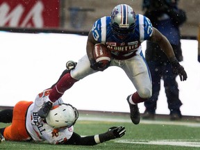 Montreal Alouettes running back Brandon Rutley, right, breaks away from BC Lions linebacker Adam Bighill during CFL semifinal action at Molson Stadium  in Montreal on Sunday November 16, 2014.  The Alouettes won 50-17.