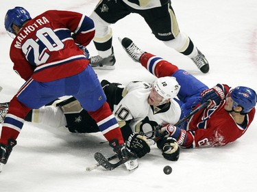 Montreal Canadiens Manny Malhotra and Max Pacioretty look for loose puck with  Pittsburgh Penguins Christan Ehrhoff during National Hockey League game in Montreal Tuesday November 18, 2014.