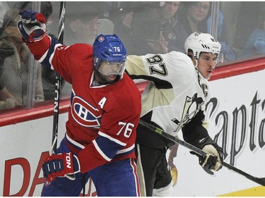 P.K. Subban and Sidney Crosby spin away from check behind the net during action in Montreal Tuesday, Nov. 18, 2014 .