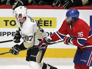 Pittsburgh Penguins Sidney Crosby, left, holds Montreal Canadiens P.K. Subban's stick during National Hockey League game in Montreal Tuesday November 18, 2014.