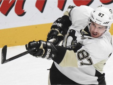 Pittsburgh Penguins Sidney Crosby follows through on a shot during warmups prior to National Hockey League game against the Canadiens in Montreal Tuesday November 18, 2014 .