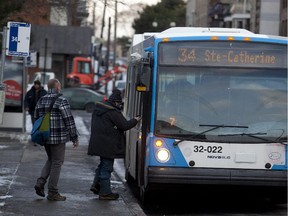 Commuters get on the 34 STM bus in Montreal, Wednesday November 19, 2014.