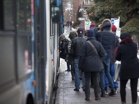 Commuters get on the 45 STM bus in Montreal, Wednesday November 19, 2014.