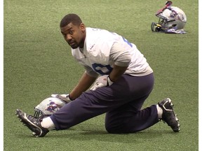 Running back Tyrell Sutton, who is recovering from an ankle injury, stretches at practice Wednesday.