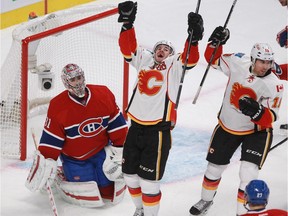 MONTREAL, QUE.: NOVEMBER 2, 2014 -- Goalie Carey Price of the Montreal Canadiens looks up as Curtis Glencross (centre) and David Jones of the Calgary Flames celebrate after Glencross scored in the second period of an N.H.L. game at the Bell Centre in Montreal Sunday, November 2, 2014 to put the Flames up 3-0. (John Kenney / MONTREAL GAZETTE)