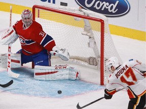 MONTREAL, QUE.: NOVEMBER 2, 2014 -- Lance Bouma of the Calgary Flames scores against Carey Price in the third period of an N.H.L. game at the Bell Centre in Montreal Sunday, November 2, 2014. It was the fifth goal of the Flames.  (John Kenney / MONTREAL GAZETTE)