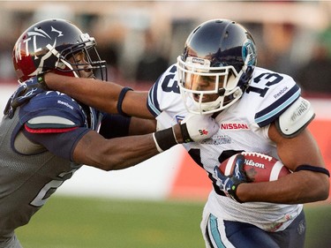 Montreal Alouettes linebacker Mike Edem, left, tackles Toronto Argonauts wide receiver LaVon Brazill during CFL action at the Molson Stadium in Montreal on Sunday November 2, 2014.