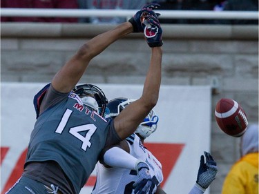 Montreal Alouettes wide receiver Brandon London, left, misses a long pass after colliding with Toronto Argonauts defensive back Orhian Johnson during CFL action at the Molson Stadium in Montreal on Sunday November 2, 2014.