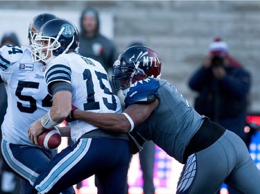 Toronto Argonauts quarterback Ricky Ray, left gets sacked by Montreal Alouettes defensive end John Bowman during CFL action at the Molson Stadium in Montreal on Sunday November 2, 2014. Ray was hurt on the play and left the field for the balance of the game.