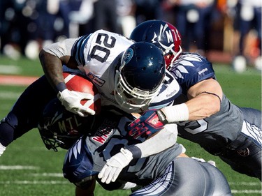 Toronto Argonauts running back Steve Slaton is stacked by the Montreal Alouettes during CFL action at the Molson Stadium in Montreal on Sunday November 2, 2014.