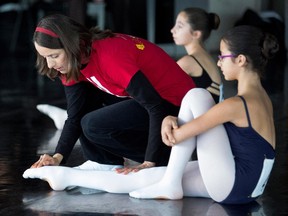 Ballet teacher Martine Lemay, left, checks the flexibility of Ely Robertson's foot as Robertson auditions with Canada's National Ballet School in Montreal on Nov. 20, 2014.