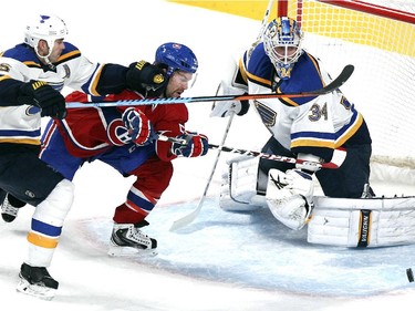 Montreal Canadiens David Desharnais is obstructed by St. Louis Blues Barret Jackman as he pursues puck in front of goalie Jake Allen during National Hockey League game in Montreal Thursday November 20, 2014.