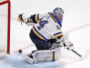 The puck passes through the crease behind St. Louis Blues goalie Jake Allen during National Hockey League game against the Canadiens in Montreal Thursday November 20, 2014.