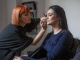 M.A.C makeup artist Angie Mandino applies makeup on actor Lucie Laurier. Balancing texture is key to holiday makeup, Mandino says.