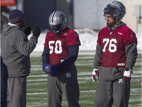 D.J. Roberts (left) and Scott Paxson take a break during a chilly outdoor practice at Molson Stadium on  Nov. 21, 2014.