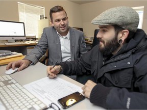 West Island Youth Action director general Benoit Langevin, left, meets with youth outreach worker Christophe Hotte at their office in St-Genevieve on Friday Nov. 21, 2014.