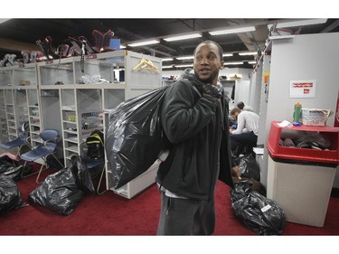 Montreal Alouettes Brandon Whittaker carries his things over his shoulder after cleaning out his locker at the Olympic Stadium in Montreal Monday November 24, 2014 one day after ending their season with a loss to Hamilton in the CFL Eastern Final.
