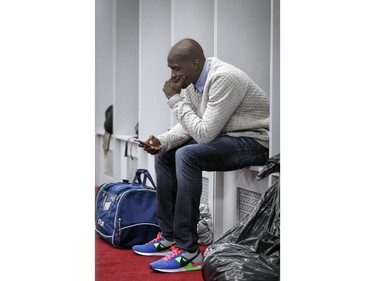 Montreal Alouettes Chad Johnson looks out his phone while cleaning his out his locker at the Olympic Stadium in Montreal Monday November 24, 2014 one day after ending their season with a loss to Hamilton in the CFL Eastern Final.