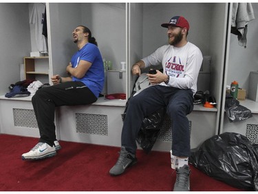 Montreal Alouettes quarterbacks Jonathan Crompton, left, and Tanner Marsh joke around while cleaning out their lockers at the Olympic Stadium in Montreal Monday November 24, 2014 one day after ending their season with a loss to Hamilton in the CFL Eastern Final.